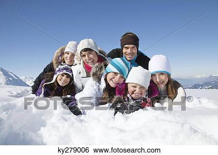 Happy family lying in snow View Large Photo Image Stock Photograph - Happy family lying in snow. Fotosearch