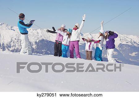 Man taking picture of family in snow View Large Photo Image Stock Image - Man taking picture of family in snow. Fotosearch