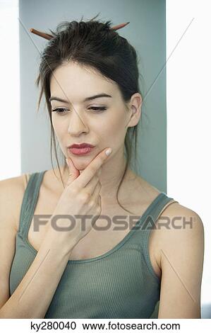 Close-up of a woman thinking View Large Photo Image Stock Image - Close-up of a woman thinking. Fotosearch