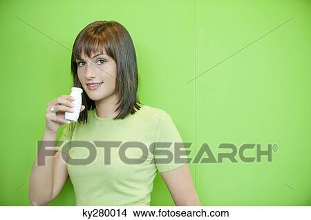 Picture - Portrait of a woman drinking probiotic drink. Fotosearch