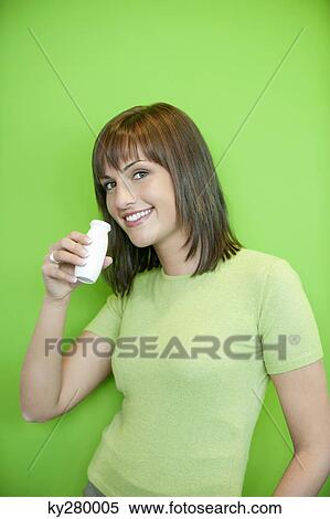 Portrait of a woman drinking probiotic drink View Large Photo Image Stock Photography - Portrait of a woman drinking probiotic drink. Fotosearch
