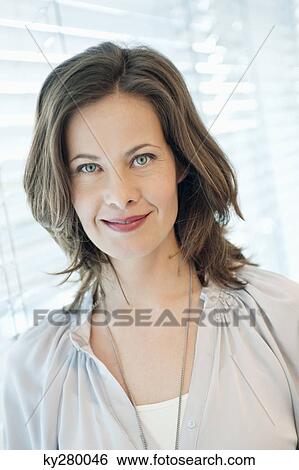 Portrait of a woman smiling View Large Photo Image Stock Photograph - Portrait of a woman smiling. Fotosearch