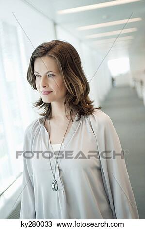 Woman looking out of a window View Large Photo Image Stock Image - Woman looking out of a window. Fotosearch
