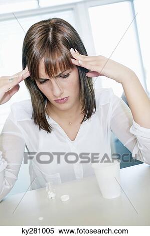 Stock Photography - Businesswoman suffering from a headache. Fotosearch