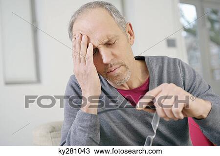 Close-up of a man suffering from a headache View Large Photo Image Stock Image - Close-up of a man suffering from a headache. Fotosearch