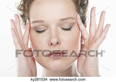 Close-up of a woman rubbing temples View Large Photo Image Picture - Close-up of a woman rubbing temples. Fotosearch