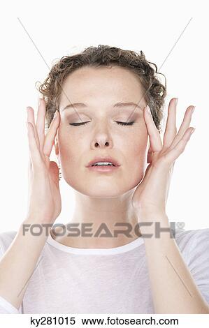 Stock Photography - Close-up of a woman rubbing temples. Fotosearch