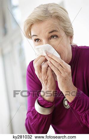 Close-up of a woman suffering from cold View Large Photo Image Stock Image - Close-up of a woman suffering from cold. Fotosearch