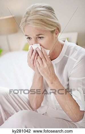 Close-up of a woman suffering from cold View Large Photo Image Stock Image - Close-up of a woman suffering from cold. Fotosearch