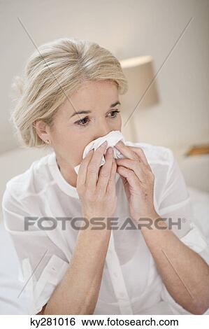 Stock Photograph - Close-up of a woman suffering from cold. Fotosearch