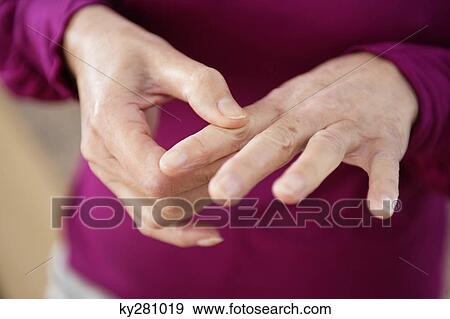 Close-up of a woman suffering from finger pain View Large Photo Image Stock Photo - Close-up of a woman suffering from finger pain. Fotosearch