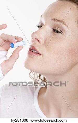 Close-up of a woman taking Homeopathic medicine View Large Photo Image Stock Photograph - Close-up of a woman taking Homeopathic medicine. Fotosearch