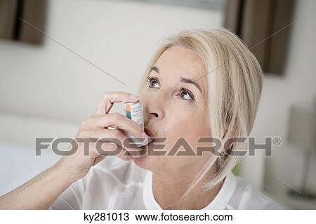 Close-up of a woman using an asthma inhaler View Large Photo Image Stock Image - Close-up of a woman using an asthma inhaler. Fotosearch