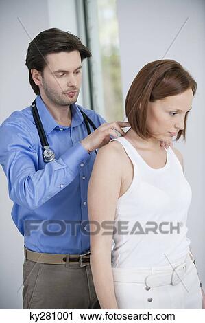 Doctor examining a patient View Large Photo Image Stock Image - Doctor examining a patient. Fotosearch