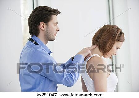 Stock Photo - Doctor examining a patient. Fotosearch