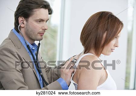 Picture - Doctor examining a patient with a stethoscope. Fotosearch