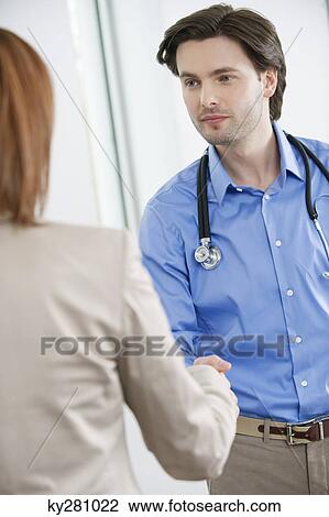 Doctor shaking hand with a woman View Large Photo Image Stock Image - Doctor shaking hand with a woman. Fotosearch