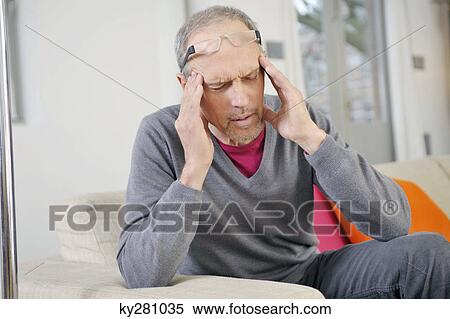 Man suffering from a headache View Large Photo Image Stock Photography - Man suffering from a headache. Fotosearch