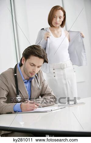Woman getting dressed after treatment View Large Photo Image Stock Image - Woman getting dressed after treatment. Fotosearch