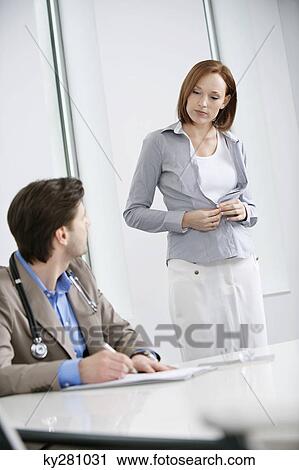 Woman getting dressed after treatment View Large Photo Image Stock Image - Woman getting dressed after treatment. Fotosearch