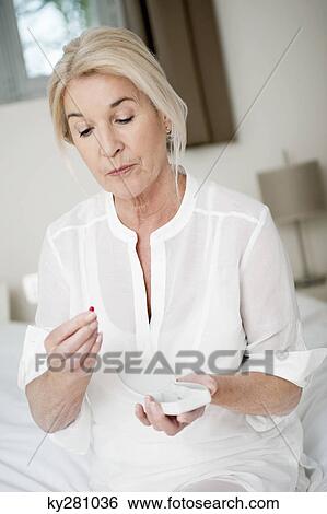 Woman taking a capsule View Large Photo Image Stock Photograph - Woman taking a capsule. Fotosearch
