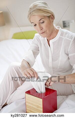 Woman taking out tissue paper from a box View Large Photo Image Stock Photo - Woman taking out tissue paper from a box. Fotosearch