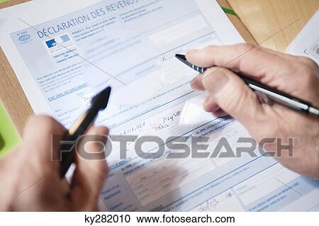 Close-up of a man's hands filling a form View Large Photo Image Stock Image - Close-up of a man's hands filling a form. Fotosearch