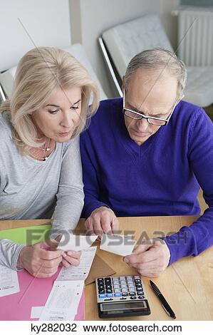 Couple sorting out bills View Large Photo Image Stock Image - Couple sorting out bills. Fotosearch