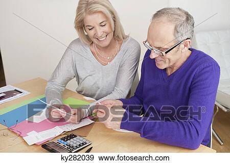 Couple sorting out bills View Large Photo Image Stock Photo - Couple sorting out bills. Fotosearch