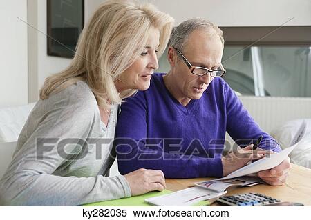Couple sorting out bills View Large Photo Image Stock Photography - Couple sorting out bills. Fotosearch