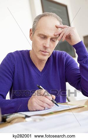 Man filling his tax form View Large Photo Image Stock Image - Man filling his tax form. Fotosearch