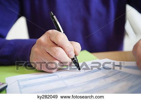 Man filling his tax form View Large Photo Image Stock Photo - Man filling his tax form. Fotosearch