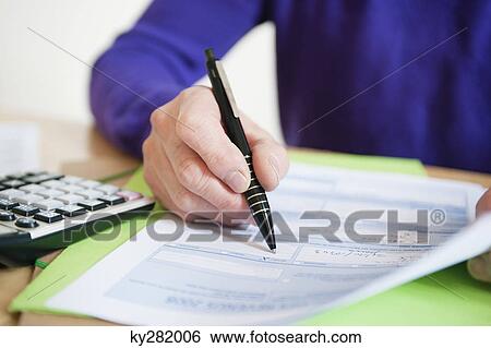 Man filling his tax form View Large Photo Image Stock Photograph - Man filling his tax form. Fotosearch