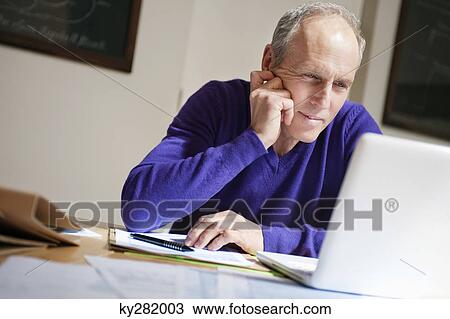 Man working on a laptop View Large Photo Image Stock Image - Man working on a laptop. Fotosearch