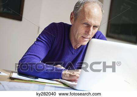 Man working on a laptop View Large Photo Image Stock Image - Man working on a laptop. Fotosearch