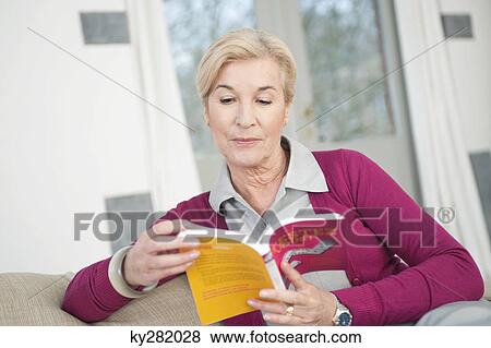 Woman reading a book View Large Photo Image Stock Photo - Woman reading a book. Fotosearch
