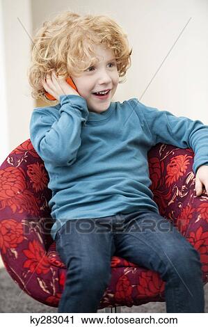 Boy talking on a mobile phone View Large Photo Image Stock Image - Boy talking on a mobile phone. Fotosearch