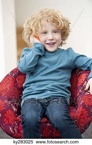 Stock Photography - Boy talking on a mobile phone. Fotosearch