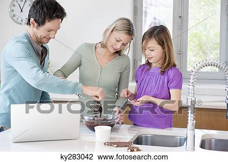 Family cooking with the recipe on a laptop View Large Photo Image Stock Image - Family cooking with the recipe on a laptop. Fotosearch