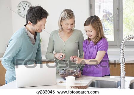 Family cooking with the recipe on a laptop View Large Photo Image Stock Photography - Family cooking with the recipe on a laptop. Fotosearch