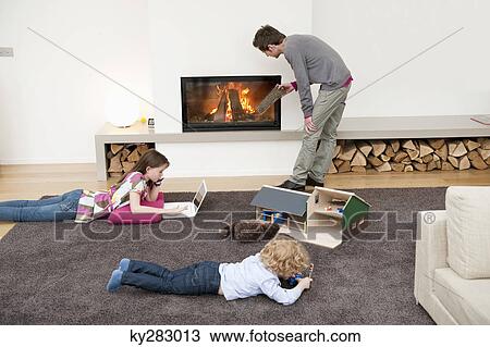 Stock Image - Family in a living room. Fotosearch