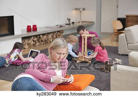 Family in a living room View Large Photo Image Stock Photo - Family in a living room. Fotosearch