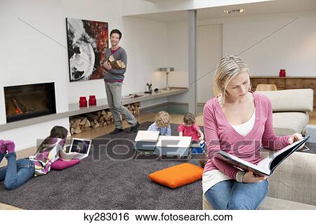 Stock Photograph - Family in a living room. Fotosearch