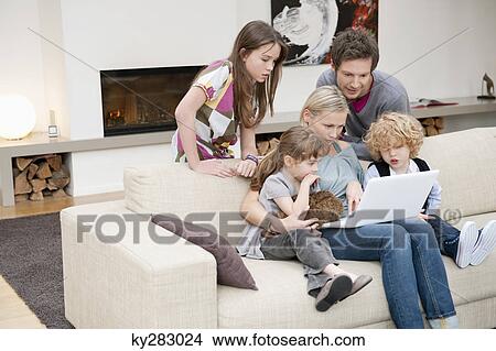 Family using a laptop View Large Photo Image Picture - Family using a laptop. Fotosearch