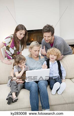 Family using a laptop View Large Photo Image Stock Photo - Family using a laptop. Fotosearch