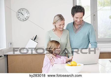 Family using a laptop View Large Photo Image Stock Photo - Family using a laptop. Fotosearch