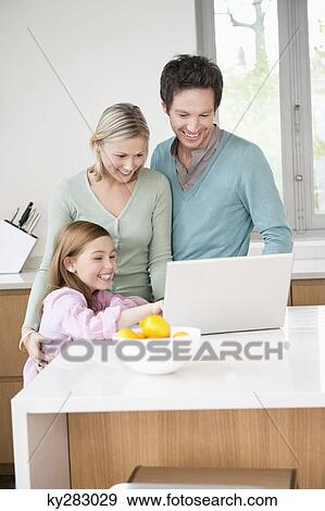 Stock Photo - Family using a laptop. Fotosearch