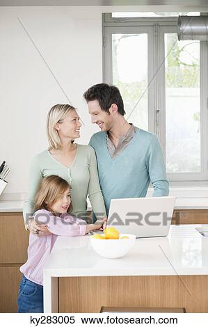 Family using a laptop View Large Photo Image Stock Photography - Family using a laptop. Fotosearch