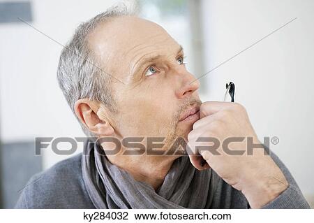 Close-up of a man thinking View Large Photo Image Stock Image - Close-up of a man thinking. Fotosearch