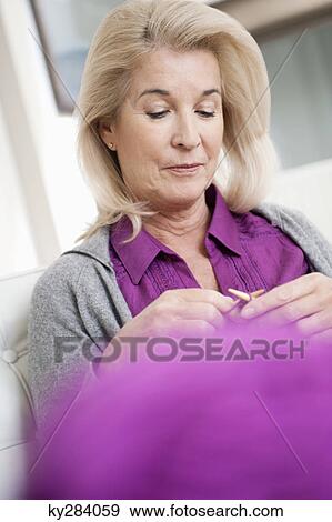 Close-up of a woman knitting View Large Photo Image Stock Photo - Close-up of a woman knitting. Fotosearch